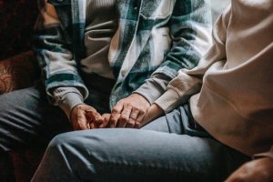 A couple holding hands, signifying the bond of trust and connection in their relationship