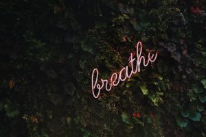 Image of a sign that reads 'Breathe' as a reminder for self-care